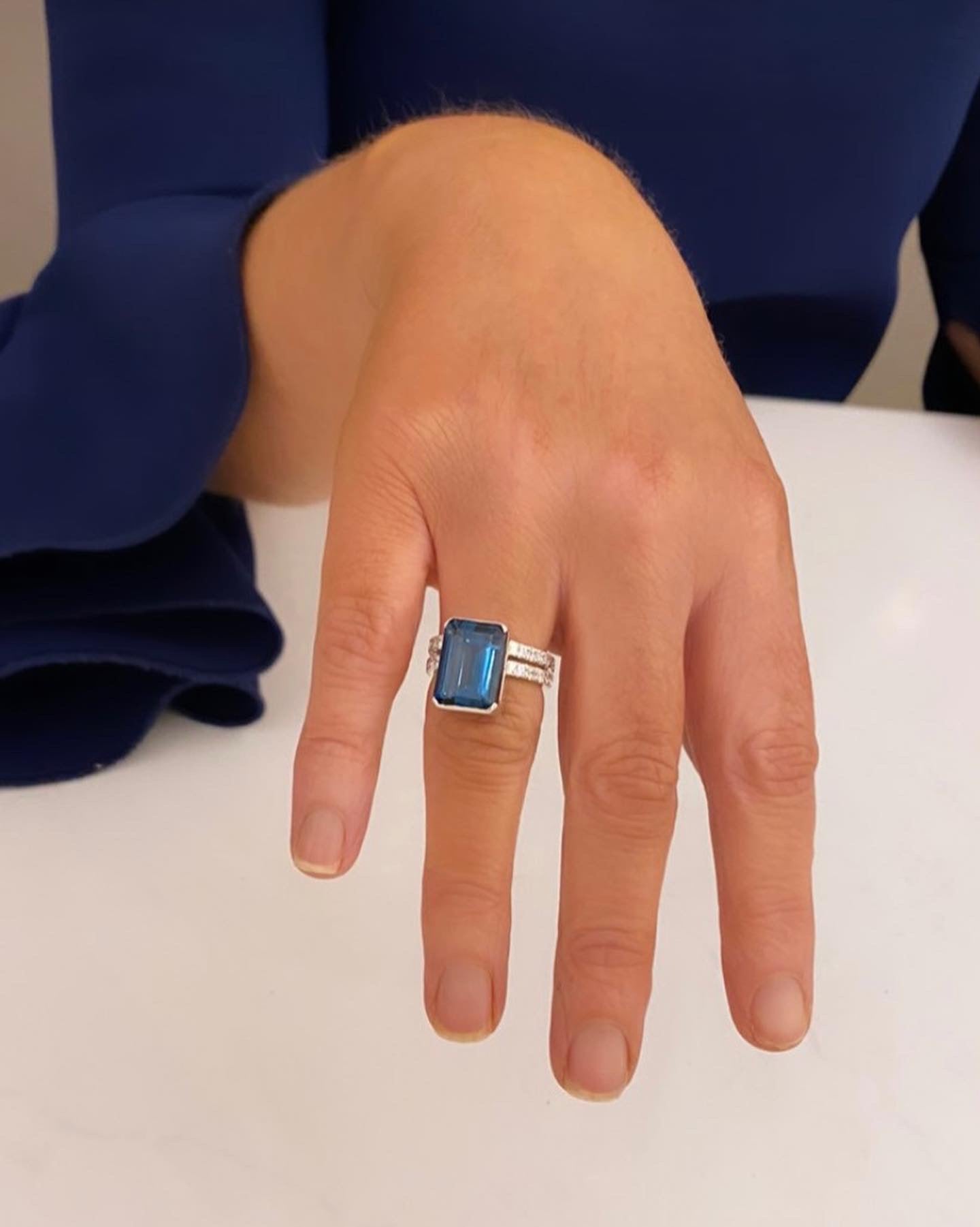 London Blue Topaz emerald cut ring set on a double band
